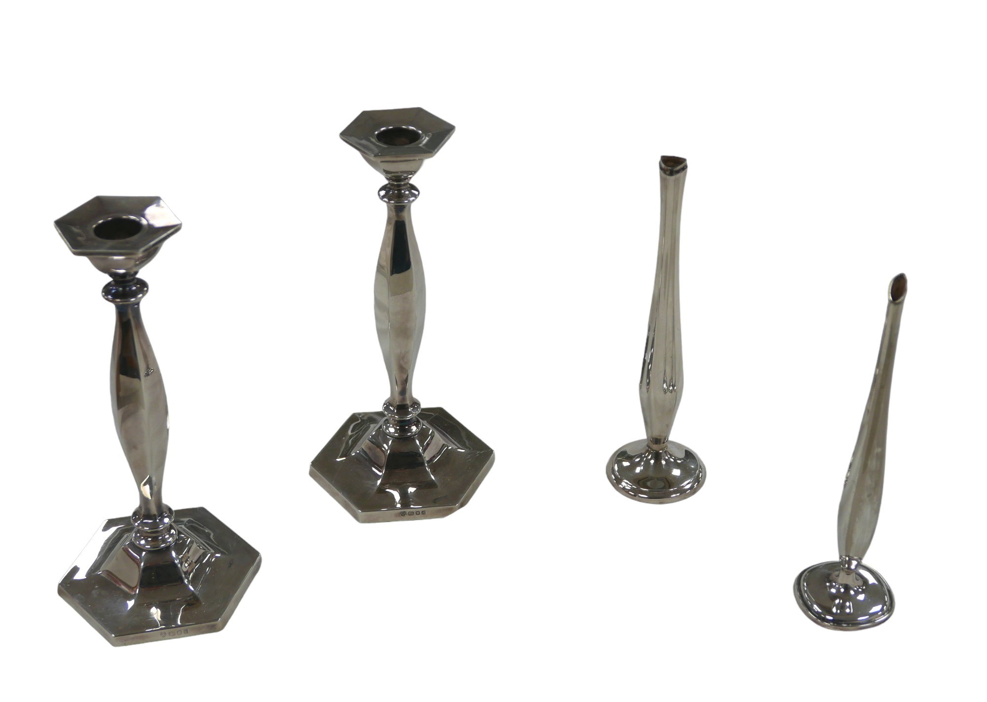 A pair of ERII silver candlesticks of hexagonal form, D J Silver Repairs, London 1975, 23cm high and
