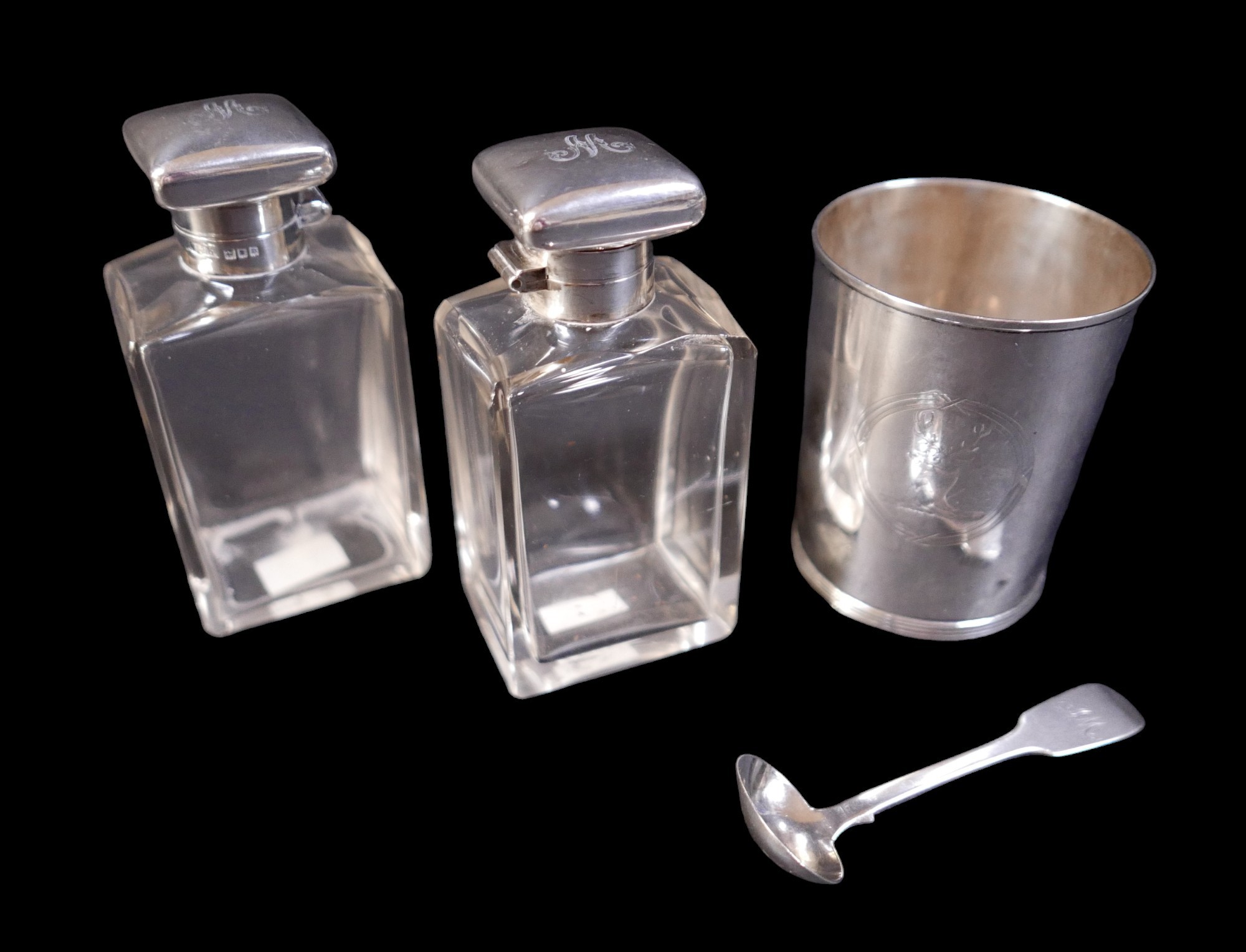 A small group of silver items, comprising a silver beaker, 7 by 9cm high, a silver mustard spoon,