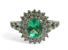 A diamond and oval emerald ring, on unmarked white gold band (testing as minimum of 14k, probably