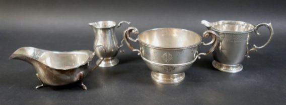 A group of four silver items, comprising a sparrow beak cream jug, milk jug, sauce boat and sugar