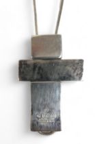 A silver box link necklace suspending a Gucci silver three section asymmetrical cross shaped