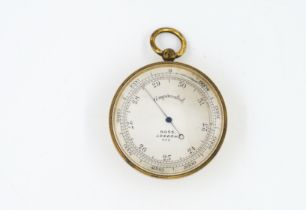 A GILT METAL CASED POCKET BAROMETER