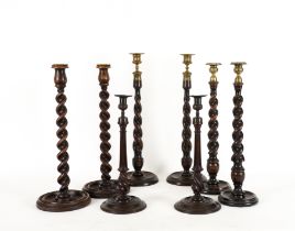 FOUR PAIRS OF GEORGE III STYLE MAHOGANY AND OAK SPIRAL TWIST CANDLESTICKS (8)