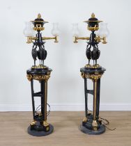 A PAIR REGENCY STYLE PATINATED AND GILT METAL THREE LIGHT TORCHERES OR FLOOR LIGHTS (2)