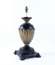 A GILT AND EBONISED TAPERING OVOID SHADED TABLE LAMP