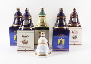 A COLLECTION OF BELLS WHISKY DECANTERS INCLUDING THREE CELEBRATING THE PRINCE OF WALES’ 50TH...