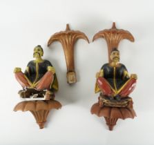 A PAIR OF CHINESE POLYCHROME DECORATED FIGURATIVE WALL MOUNTS (2)