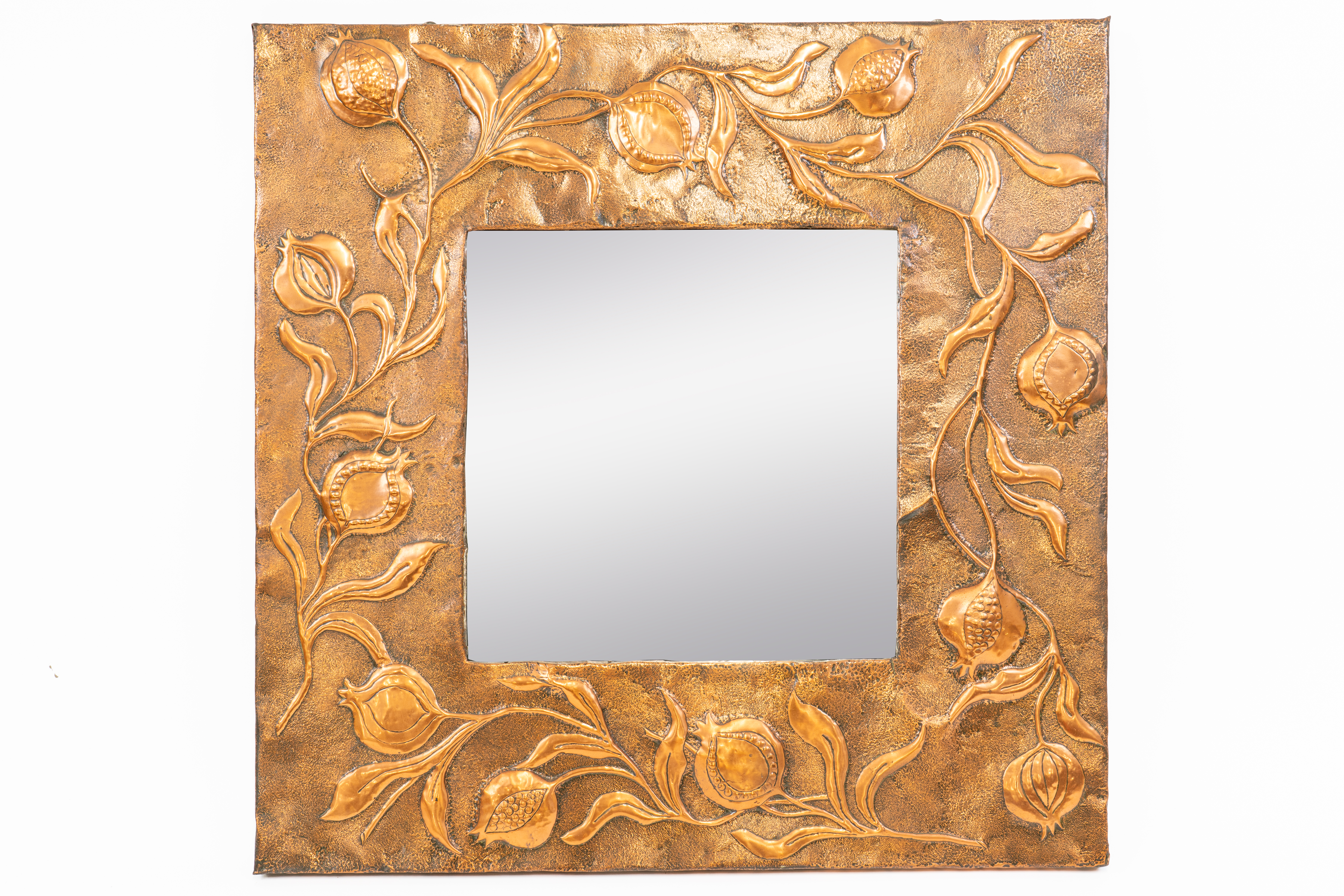 IN THE MANNER OF LIBERTY & CO; AN ARTS & CRAFTS COPPER SQUARE REPOUSSÉ WALL MIRROR