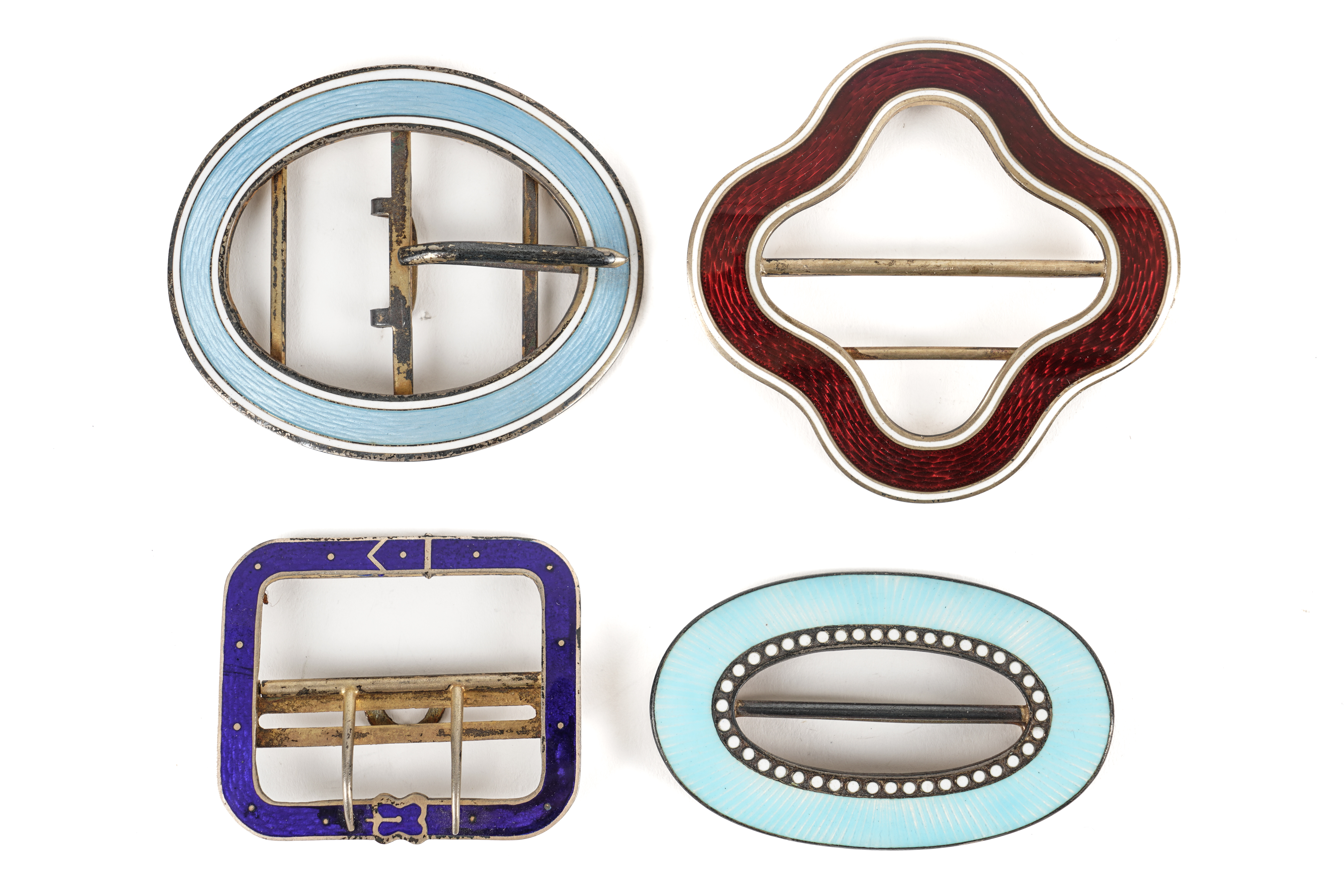 FOUR FOREIGN ENAMELLED BUCKLES (4)