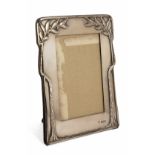 A SILVER MOUNTED SHAPED RECTANGULAR ART NOUVEAU PHOTOGRAPH FRAME