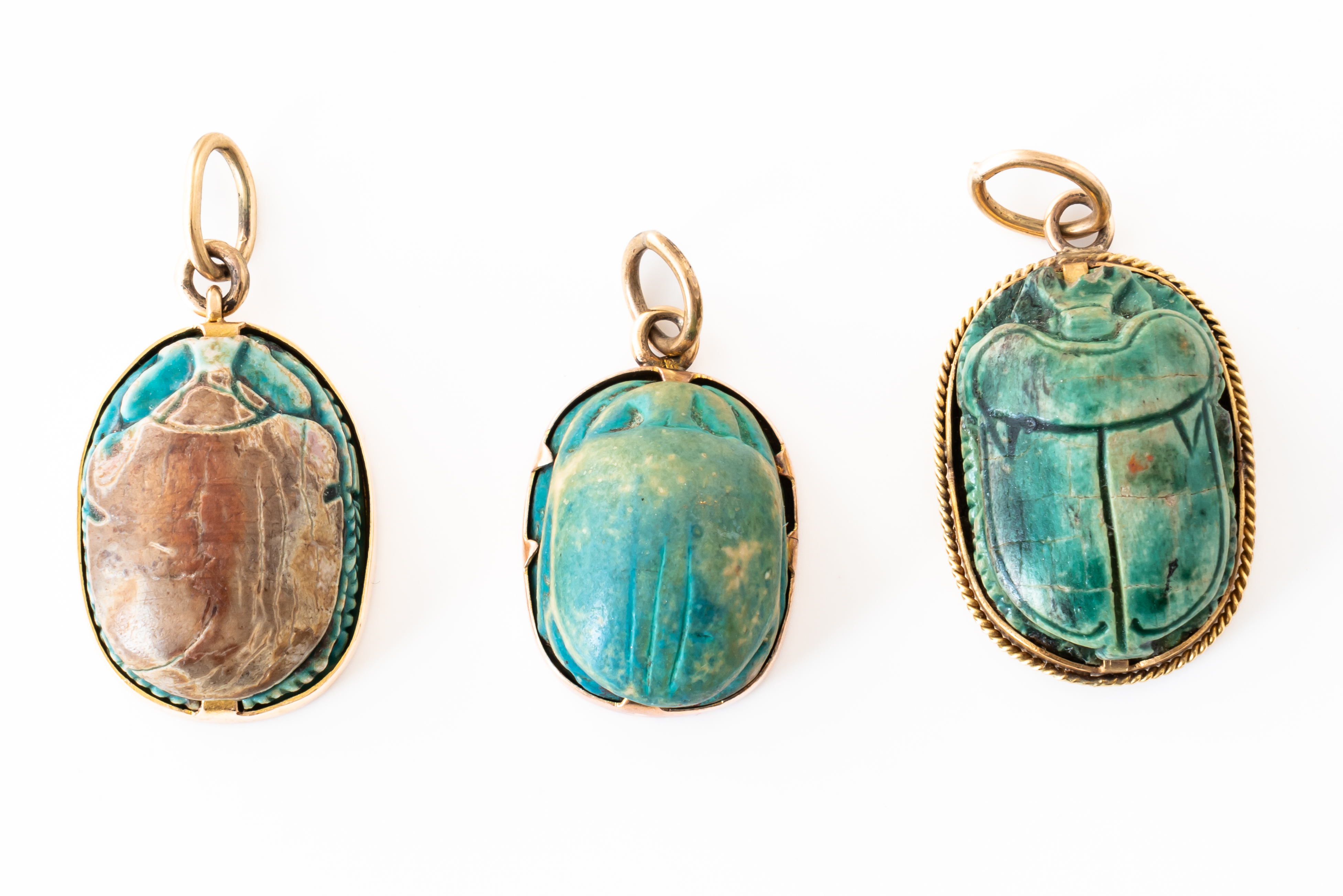 THREE GOLD MOUNTED SCARAB BEETLE PENDANTS (3)