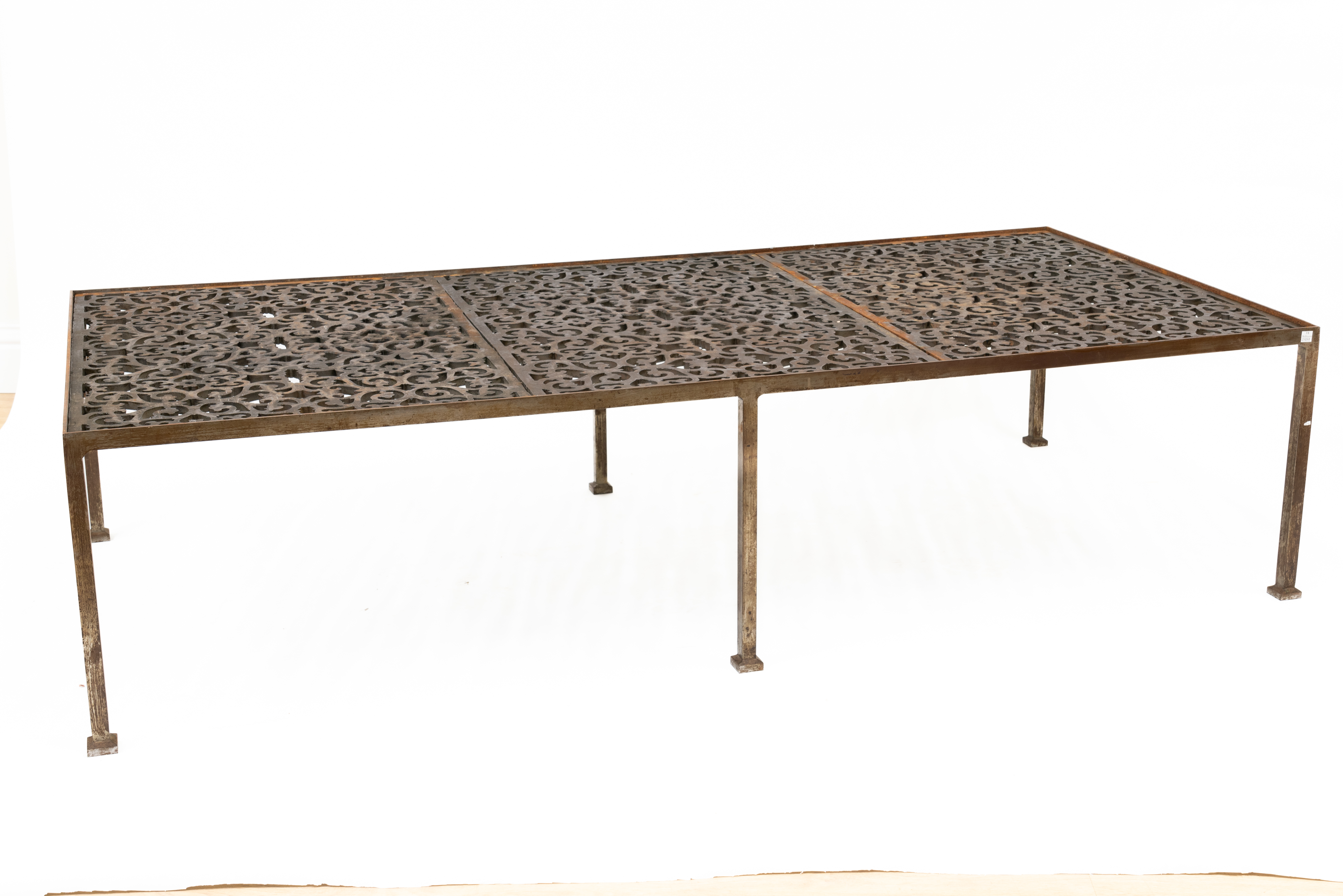 AN IRON FRAMED RECTANGULAR COFFEE TABLE