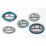 FIVE SILVER AND ENAMELLED OVAL BUCKLES (5)