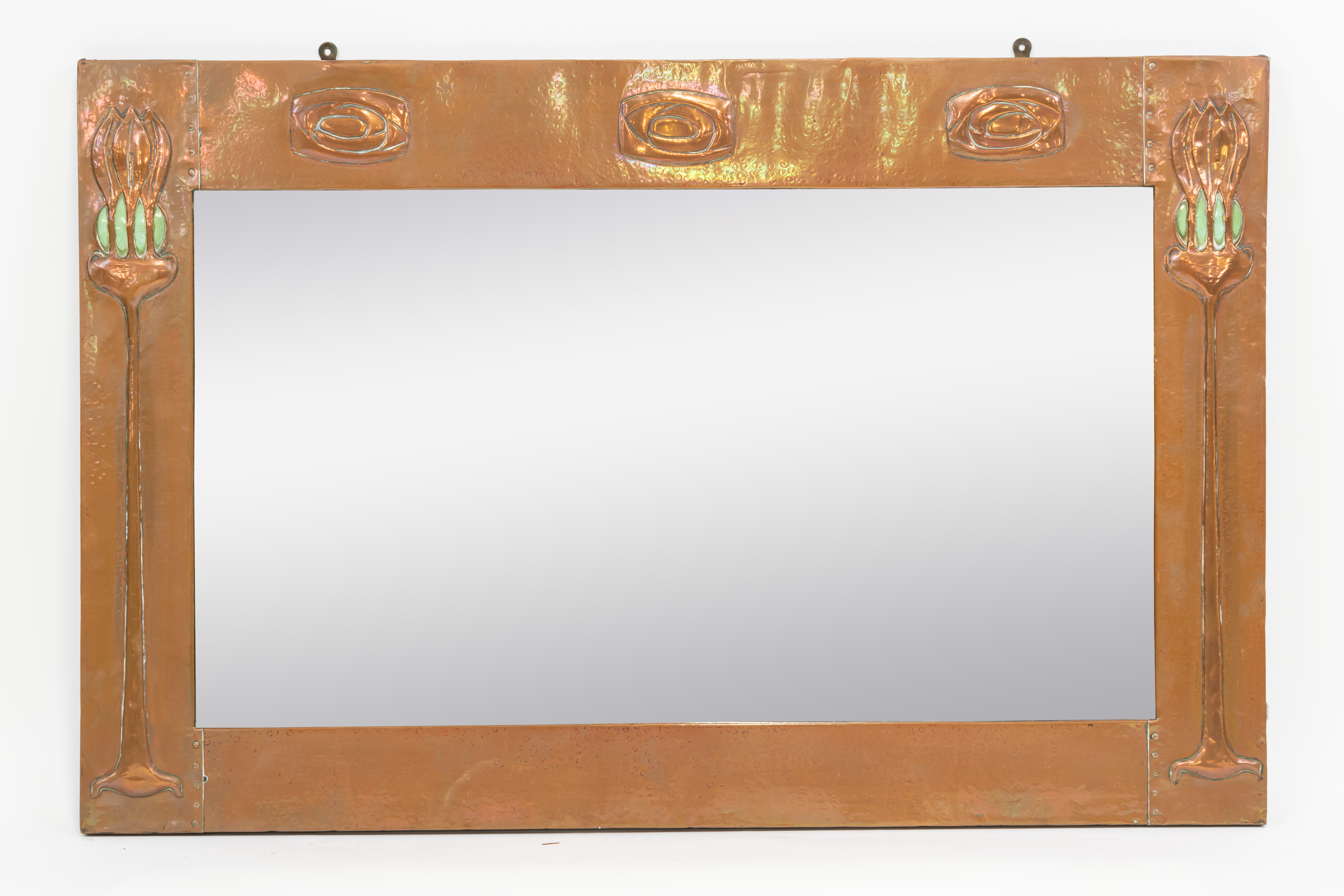 IN THE MANNER OF LIBERTY & CO; AN ARTS & CRAFTS COPPER FRAMED RECTANGULAR WALL MIRROR