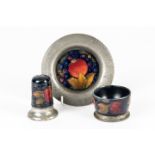 A MOORCROFT PEWTER MOUNTED SALT, PEPPER AND SMALL PLATE (3)