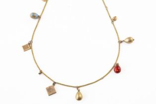 A GOLD NECKLACE FITTED WITH VARIOUS CHARMS