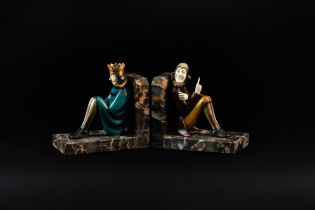 ROLAND PARIS (1894-1945): A PAIR OF COLD-PAINTED BRONZE AND IVORY FIGURAL BOOKENDS OF THE KING...