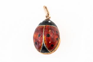 AN EARLY 20TH CENTURY ENAMEL LADYBIRD EGG CHARM