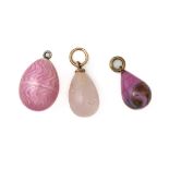 A GROUP OF THREE PINK EGG CHARMS (3)