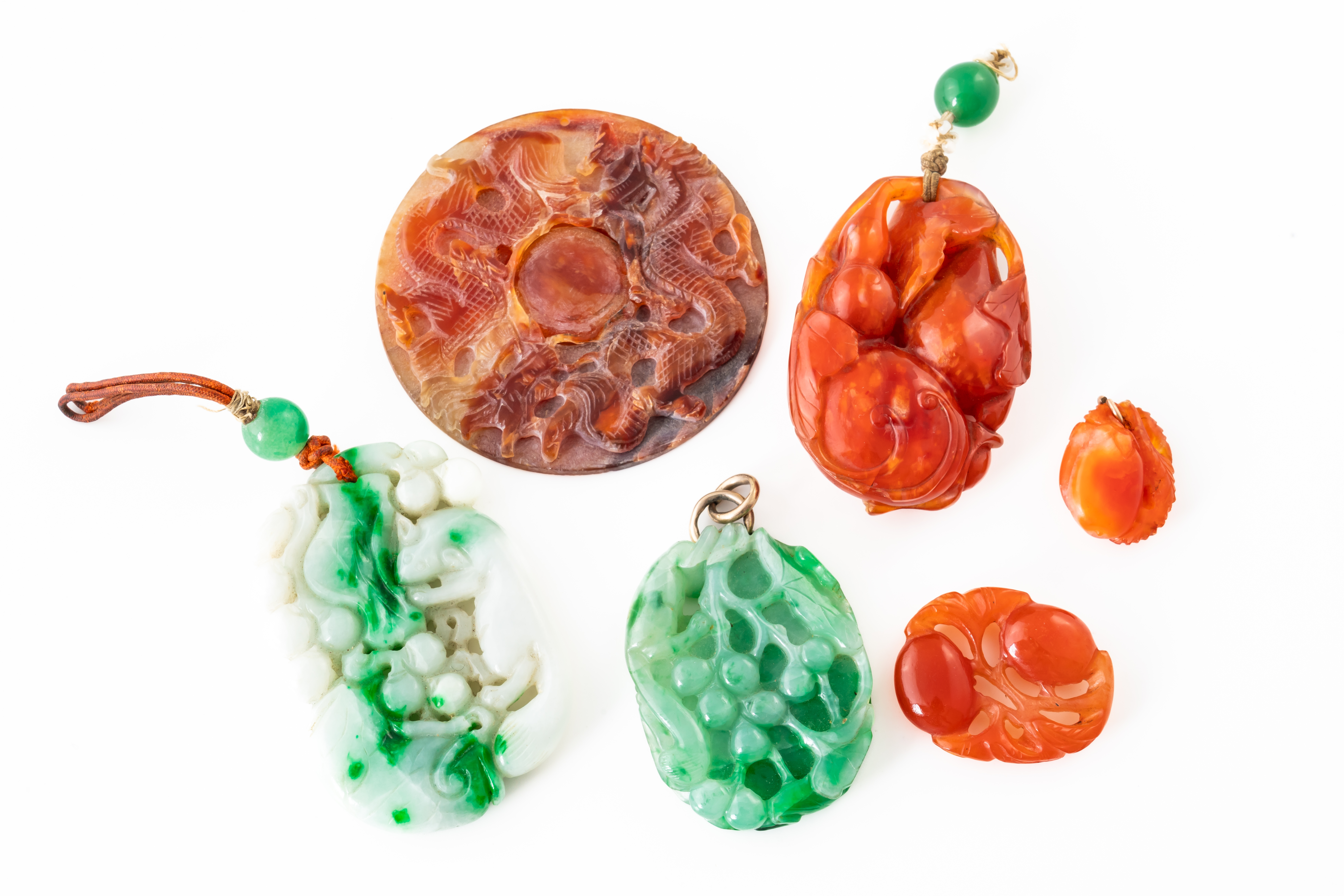 SIX CARVED ASIAN HARDSTONE PENDANTS (6)