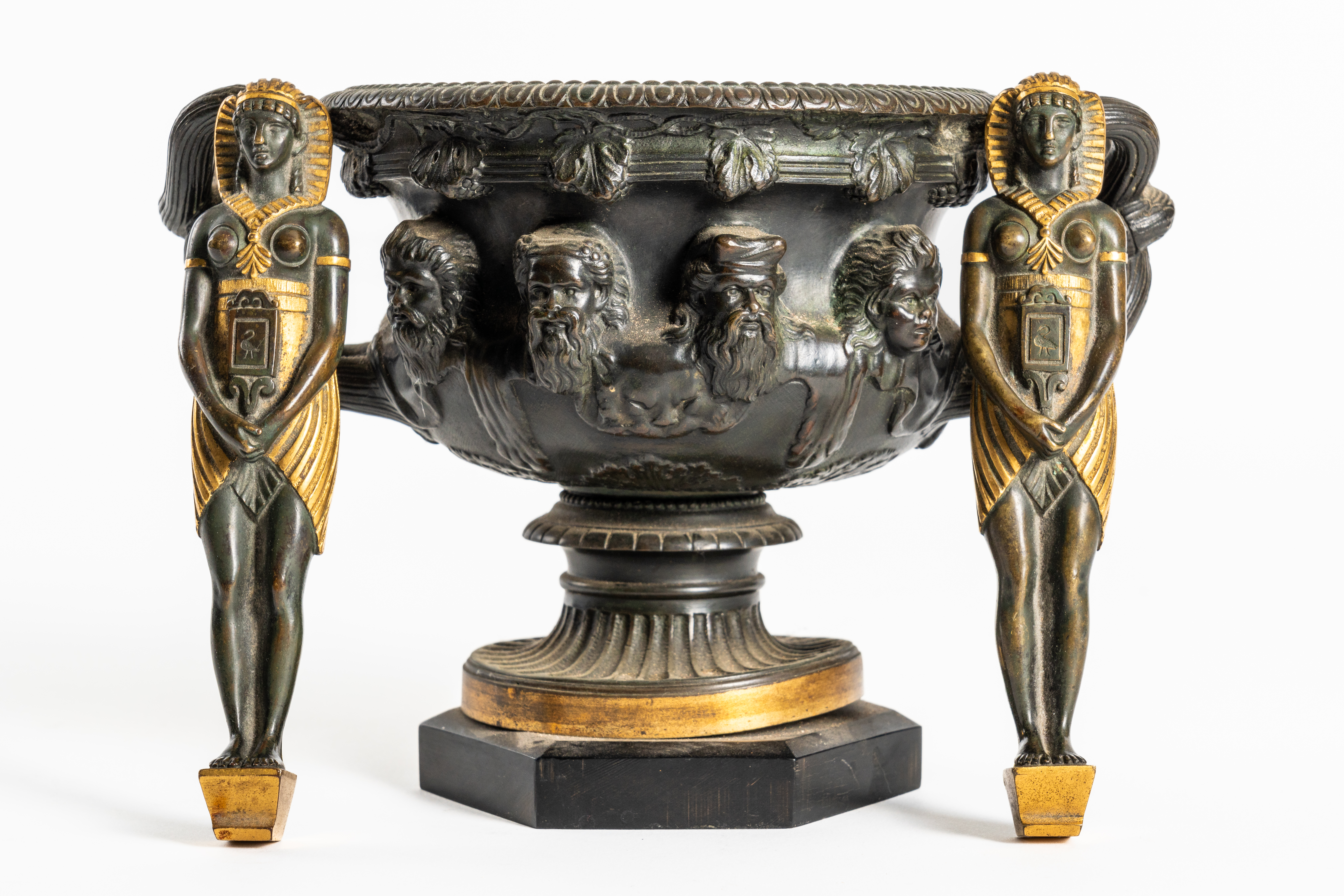 AFTER THE ANTIQUE: A PATINATED BRONZE AND GILT METAL WARWICK VASE AND TWO EGYPTIAN PHARAOH...