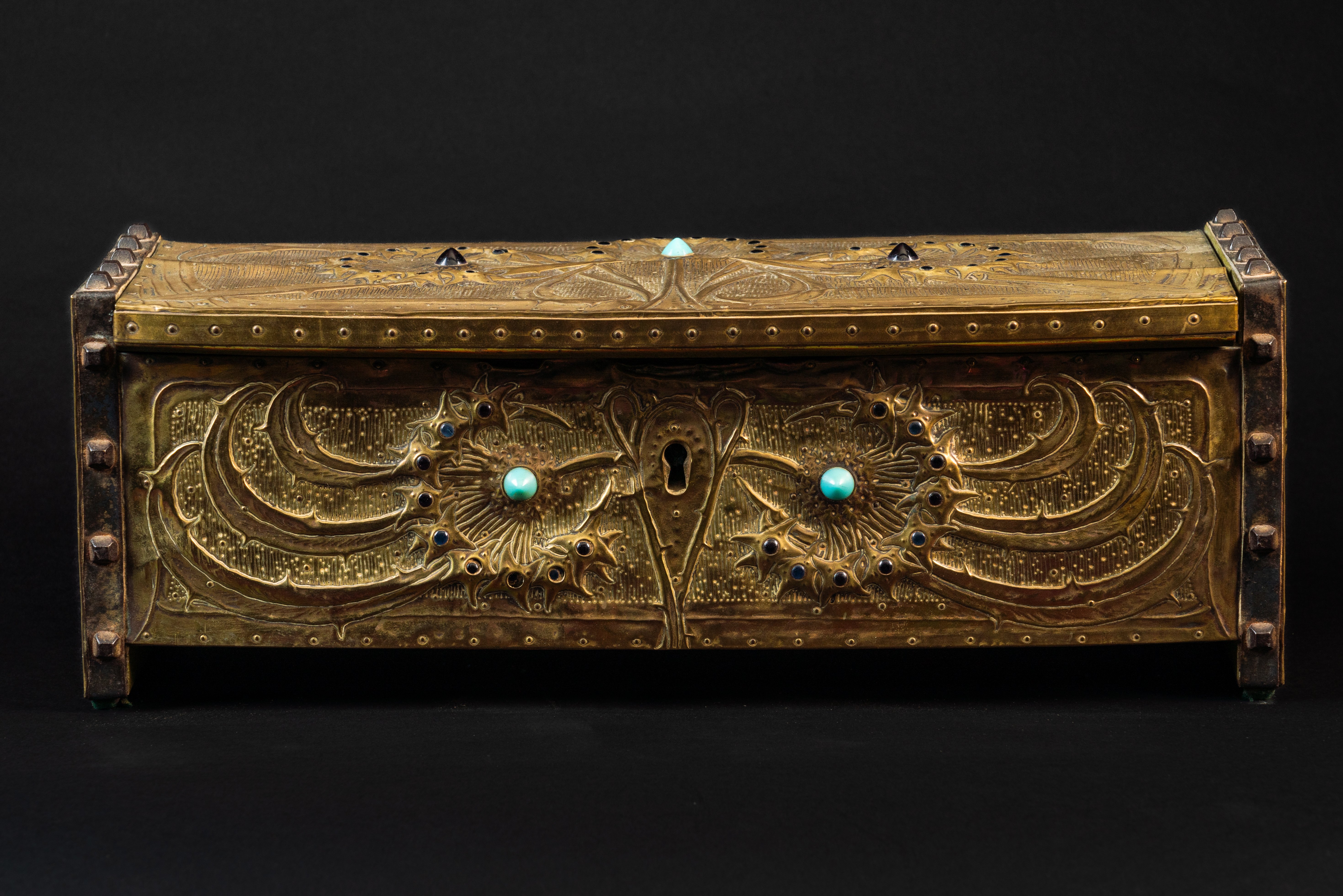 ALFRED DAGUET (1875-1942): A FRENCH ART NOUVEAU EMBOSSED GILT COPPER AND GLASS MOUNTED CASKET...