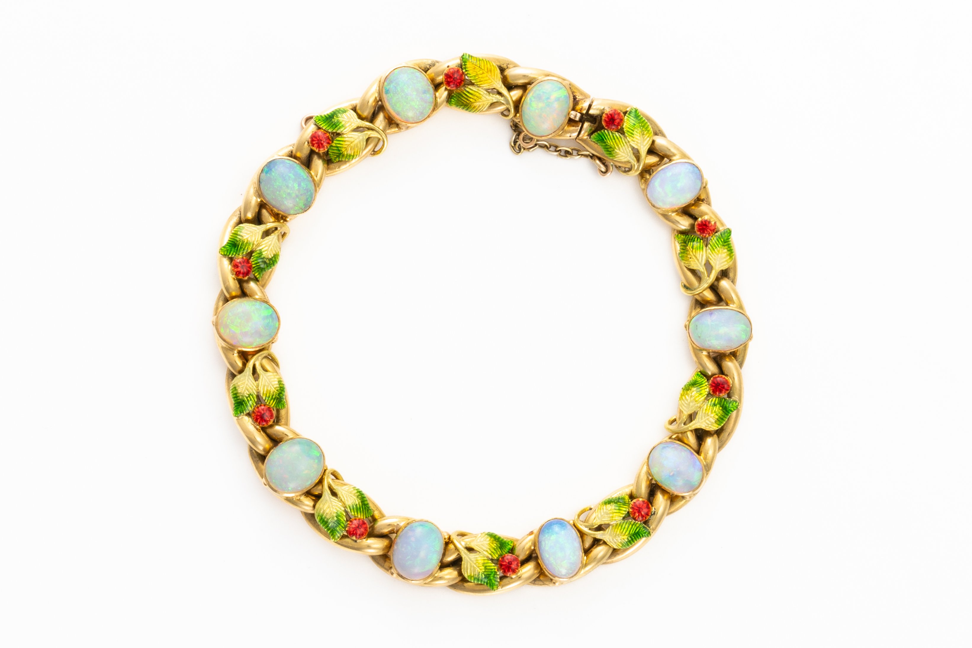 ATTRIBUTED TO MRS NEWMAN: A GOLD, OPAL AND ENAMEL BRACELET