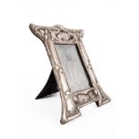 A SILVER MOUNTED SHAPED RECTANGULAR ART NOUVEAU PHOTOGRAPH FRAME