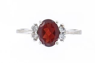 A WHITE GOLD, GARNET AND DIAMOND RING