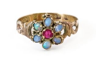 A VICTORIAN 9CT GOLD, OPAL AND RED GEM SET SEVEN STONE CLUSTER RING