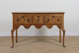 A QUEEN ANNE STYLE FEATHER BANDED WALNUT THREE DRAWER SIDE TABLE