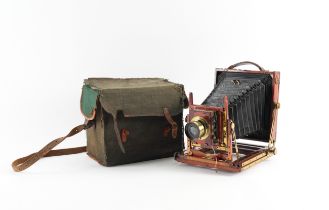 A HOUGHTON BUTCHER TRIPLE VICTO TRIPLE EXTENSION MAHOGANY HALF PLATE FIELD CAMERA WITH...