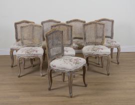 A SET OF EIGHT FRENCH CANED BACK UPHOLSTERED DINING CHAIRS (8)