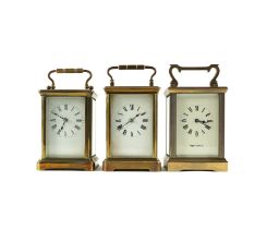 THREE BRASS CARRIAGE CLOCKS WITH CASES (6)