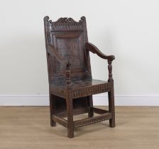 A 17TH CENTURY AND LATER CARVED OAK PANEL BACK WAINSCOT ARMCHAIR