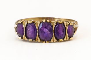 A FIVE STONE AMETHYST RING