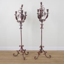 A PAIR OF RED PAINTED WROUGHT IRON THREE BRANCH FLOOR STANDING CANDLEABRA (2)