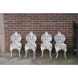 A SET OF FOUR VICTORIAN WHITE PAINTED CAST IRON GARDEN CHAIRS (4)