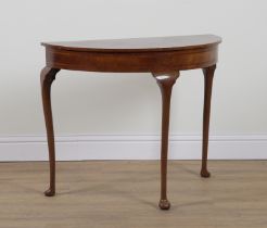 A GEORGE III STYLE FEATHER BANDED RADIAL WALNUT VENEERED DEMI-LUME CONSOLE TABLE