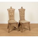 A NEAR PAIR OF GOTHIC STYLE OAK HALL CHAIRS (2)