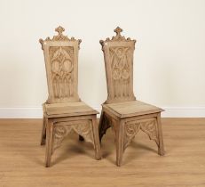 A NEAR PAIR OF GOTHIC STYLE OAK HALL CHAIRS (2)
