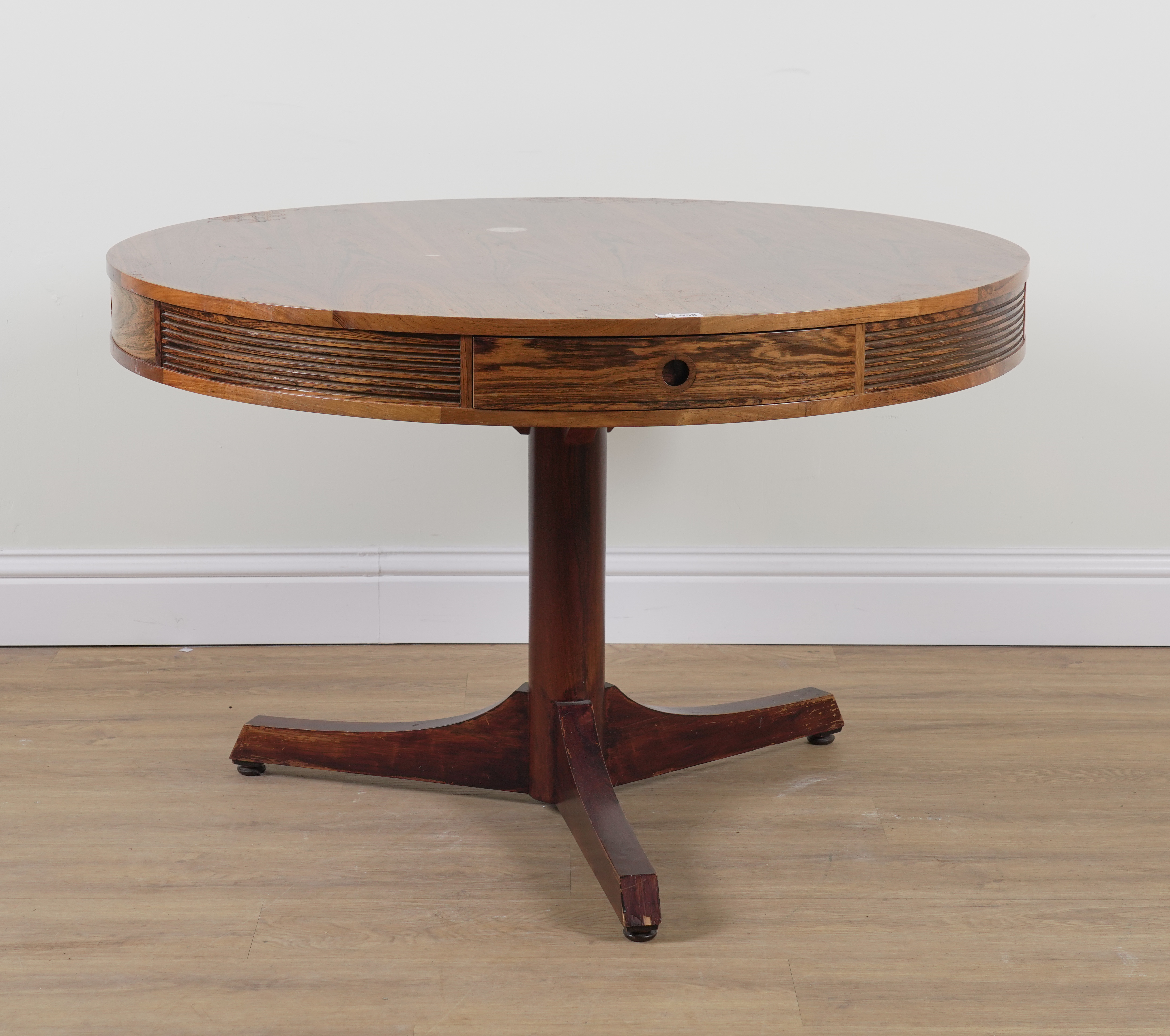 PROBABLY ARCHIE SHINE FOR HEALS FURNITURE; A MID-20TH CENTURY ROSEWOOD CIRCULAR DINING TABLE