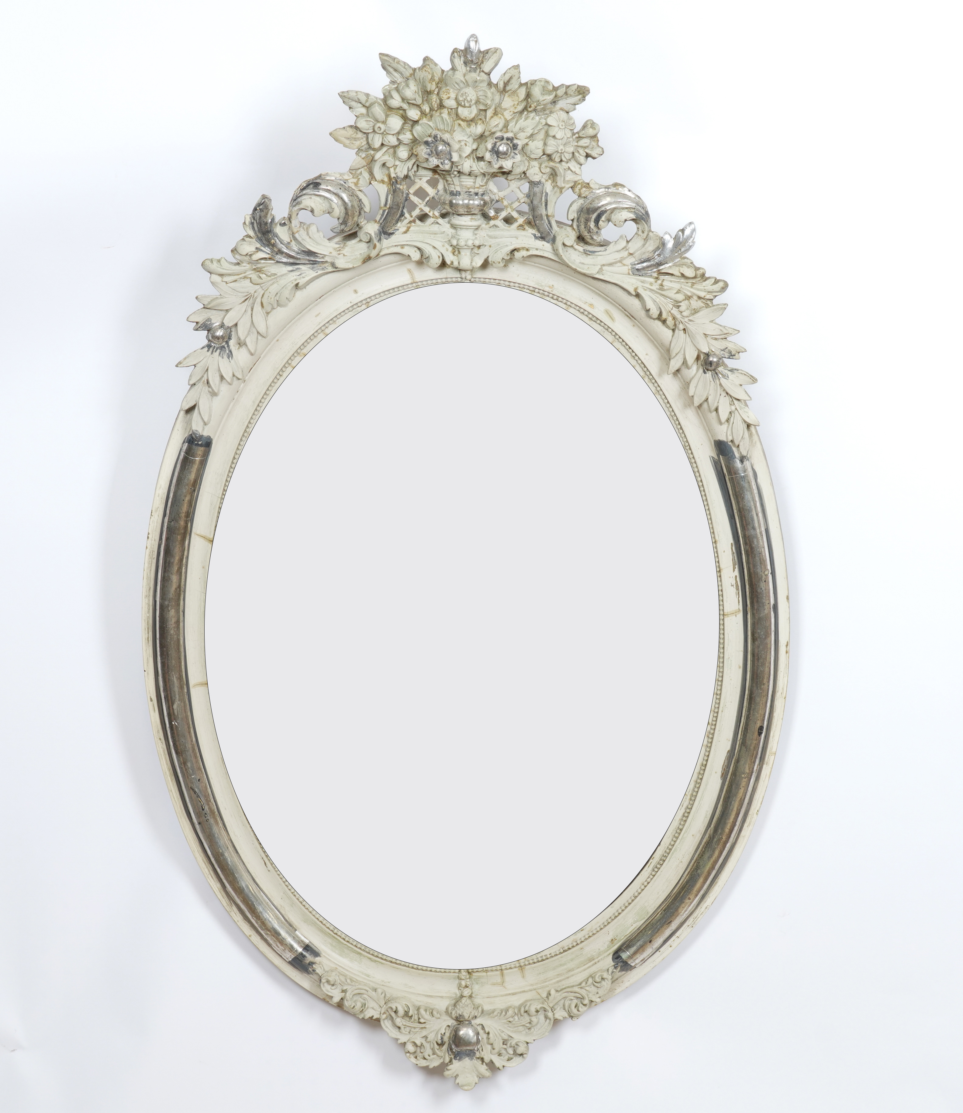 A 19TH CENTURY FRENCH SILVER AND CREAM PAINTED OVAL MIRROR