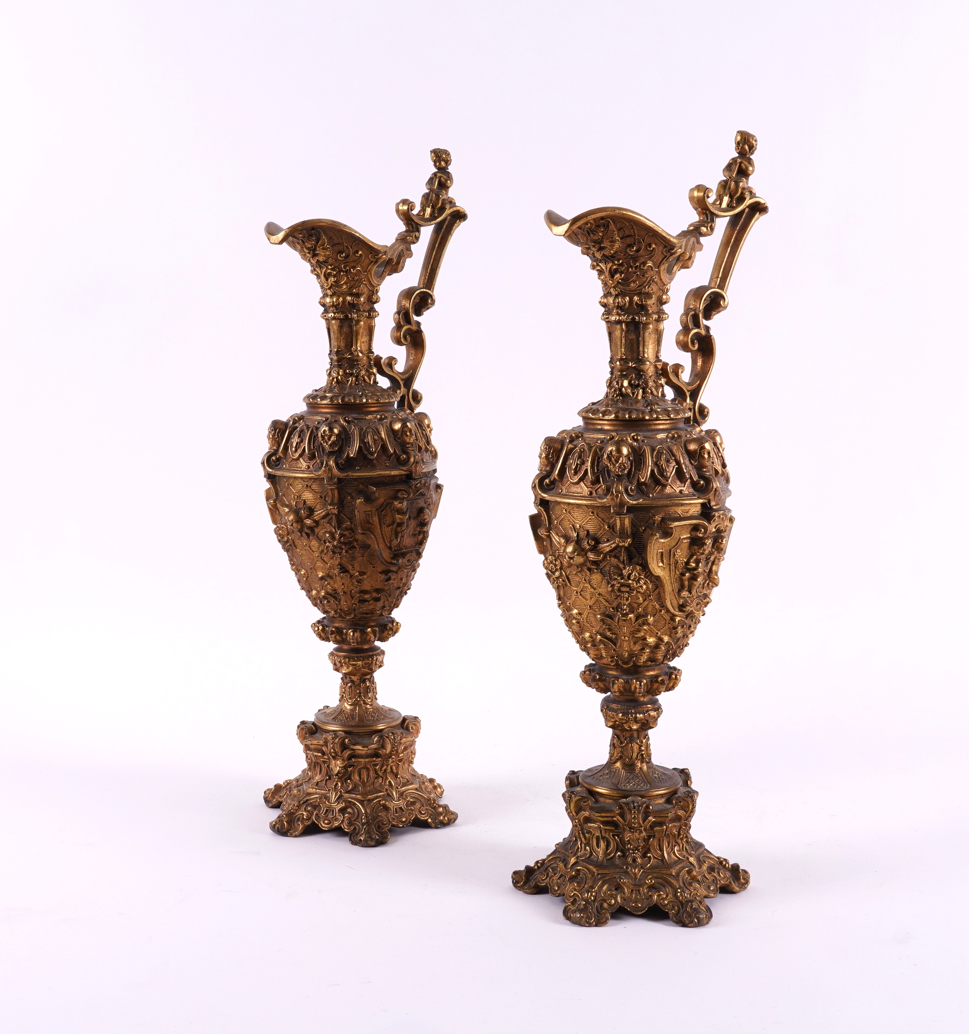 A PAIR OF LATE VICTORIAN GILT-METAL ORNAMENTAL EWERS (2)