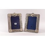 A PAIR OF SILVER MOUNTED SHAPED RECTANGULAR PHOTOGRAPH FRAMES (2)