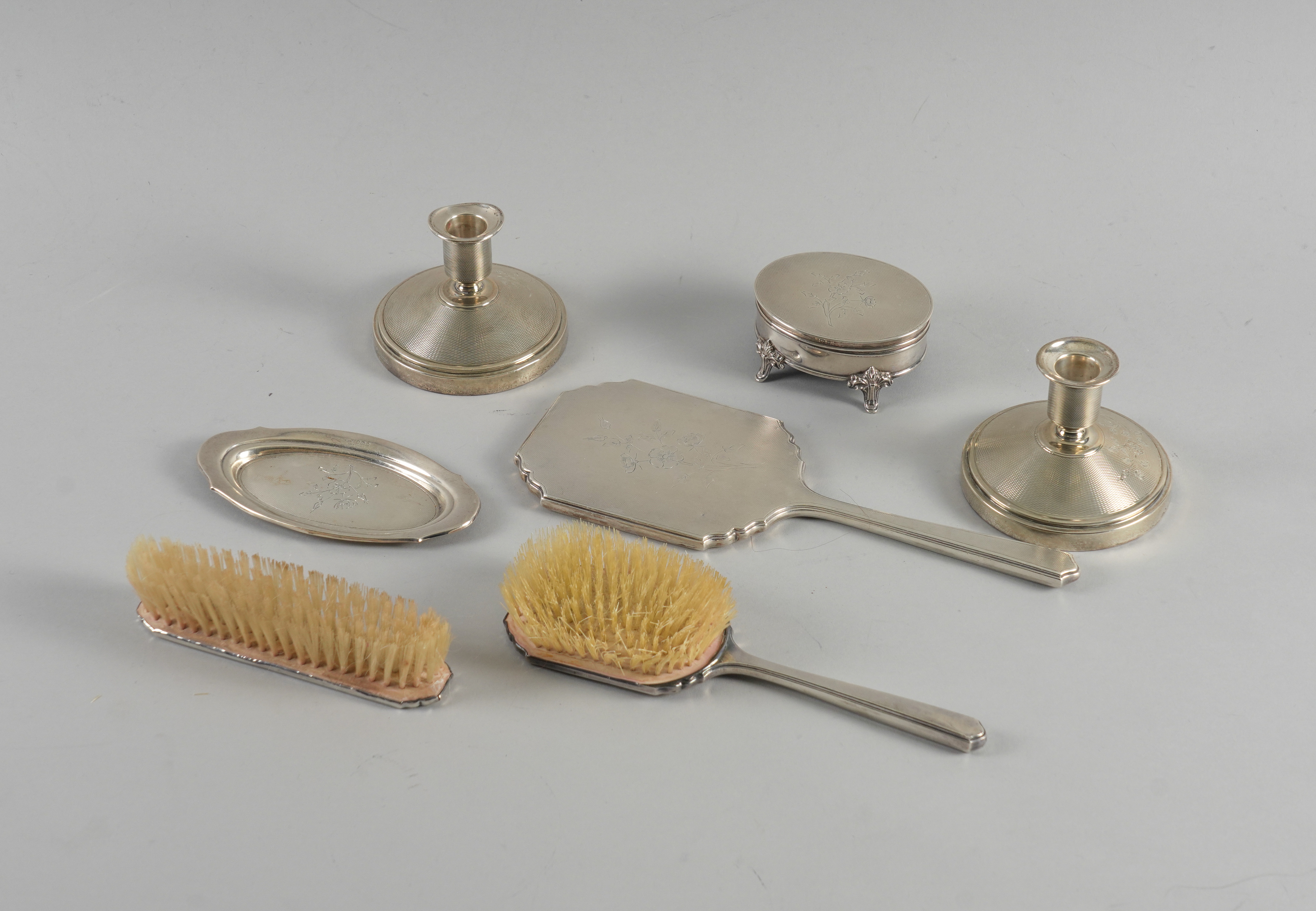 A SILVER MOUNTED SEVEN PIECE DRESSING SET