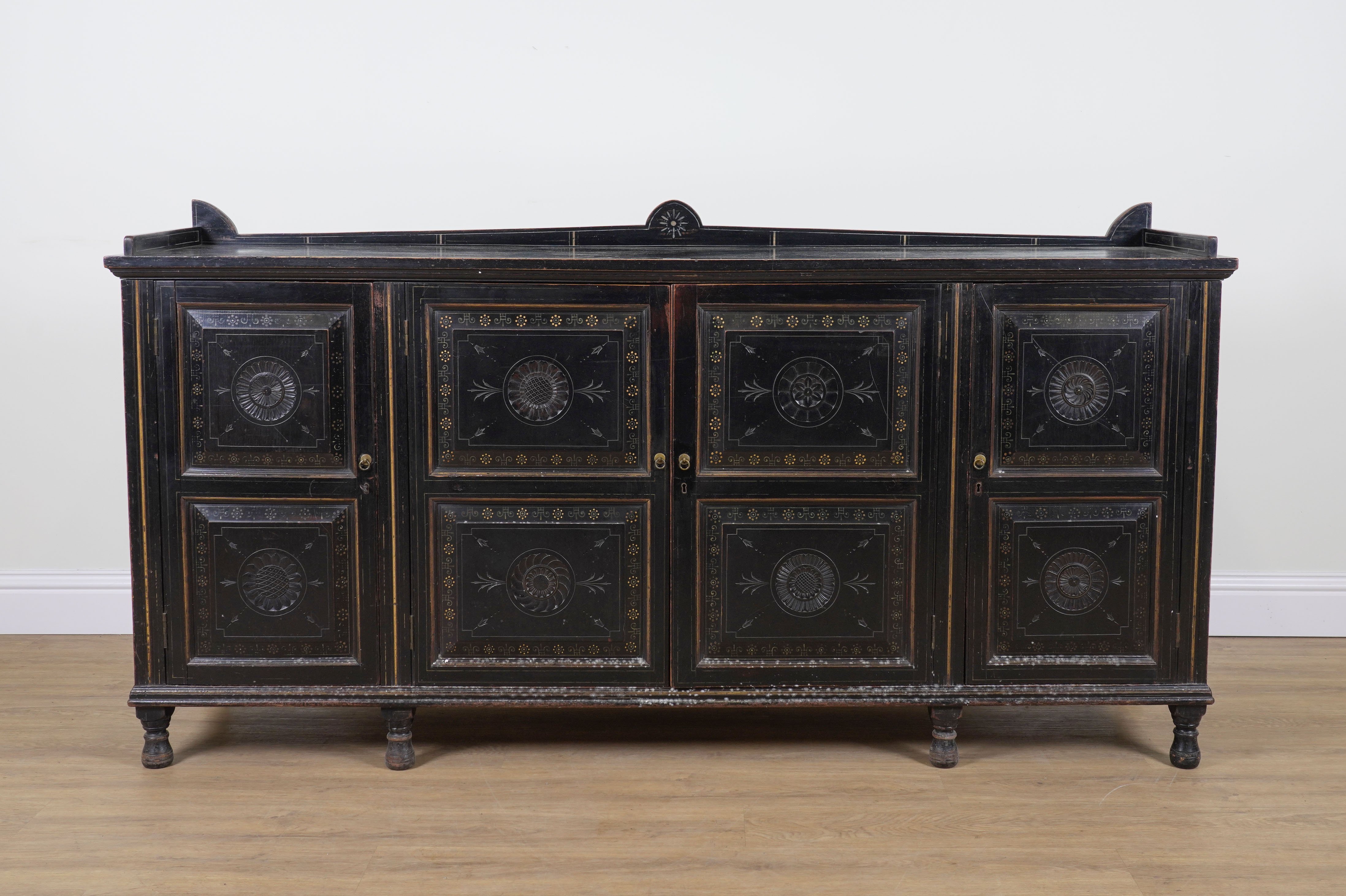 AN AESTHETIC MOVEMENT BLACK LACQUER AND POLYCHROME PAINTED FOUR DOOR SIDE CABINET