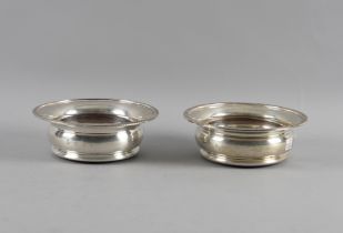 A PAIR OF SILVER COASTERS