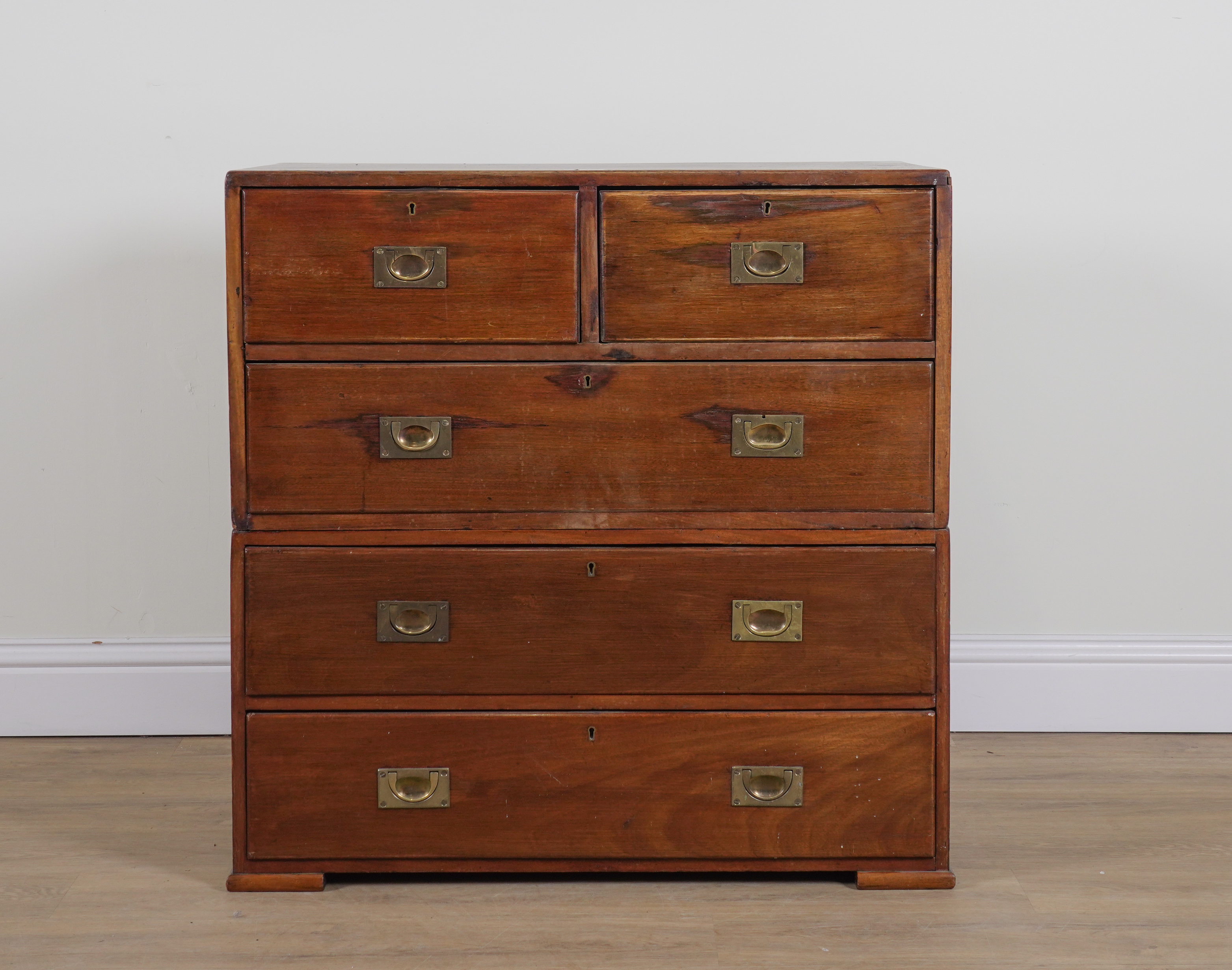AN EARLY 20TH CENTURY TEAK FIVE DRAWER TWO PART CAMPAIGN STYLE CHEST