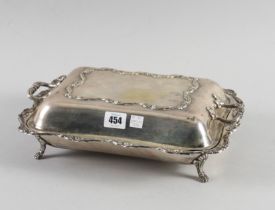 A PERUVIAN SHAPED RECTANGULAR ENTREE DISH WITH TWIN HANDLED COVER